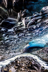 An icy river carries melt water through an ice cave in the glacier. Vatnajokull glacier in southeast Iceland.