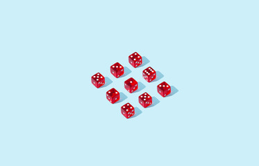 Red dices in a square shape on birght blue background. 