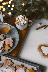 Christmas background with homemade gingerbread and hot cocoa, christmas lights