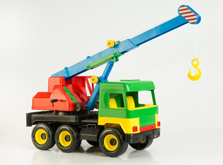 Hoisting crane. Multi-colored plastic toy cars for children.