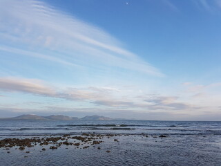 Moon visits daytime waves