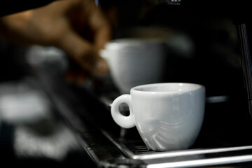 Coffee cup on a coffee machine at a coffee shop. Still details. High quality photo