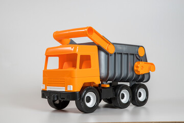 Naklejka premium Multi-colored plastic children's toy cars on a white background. Truck.
