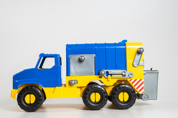 Multi-colored plastic children's toy cars on a white background.