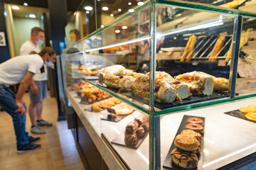 Exhibition of delicious pastries behind a glass of a patisserie in Valencia, Spain. Blurred...