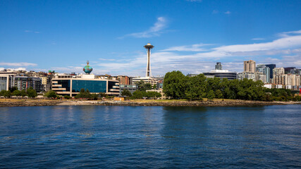 Fototapeta na wymiar Seattle, Washington, USA - June 4 2021: Seattle skyline RUN Studioes during summer. View from Elliott Bay. Space Needle. Washington state.