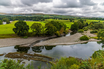 Fototapeta premium A view down the River Lune towards Kirby Lonsdale, Cumbria, UK in summertime