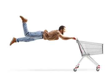 Casual man flying and holding a shopping cart