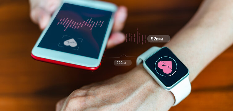 Close-up Of A Smart Watch Health Tracker With The Heart Rate Shown On The Watch And Smartphone Screens. Modern Stylish And Innovation Wearable Device