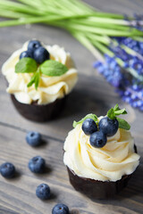 a small cupcake on the table with a beautiful cream. muffins