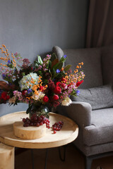 a large bouquet with red roses on a wooden table in the interior