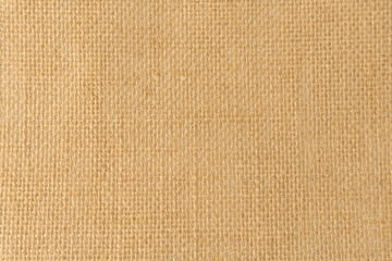 Close up burlap or hessian fabric texture for background, light brown thick rough cloth.