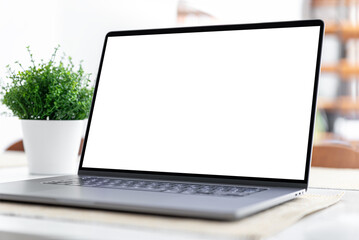 Fototapeta premium Laptop with blank screen on table in home interior
