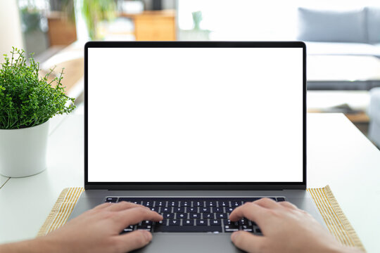 Man working on a laptop with a blank screen at his desk - POV - point of view perspective