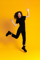 White excited woman in black t-shirt making fun and jumping