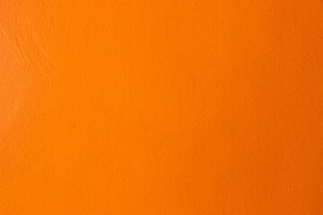 Orange color of grunge concrete textured background with copy space