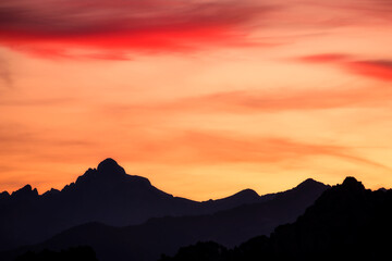 Sunrise over the silhouetted peak of Paglia Orba mountain in Corsica