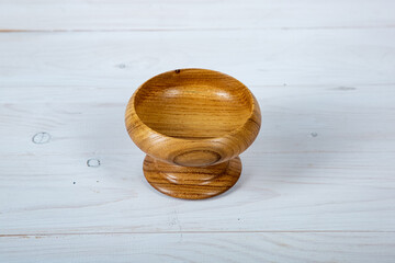 Handmade wooden tableware with a glossy lacquered surface on a white board background. Tableware made of precious wood. concept is environmentally friendly products.