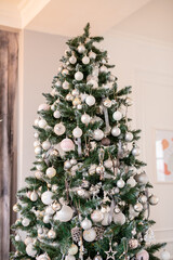 Christmas tree decorated with beautiful balloons and ribbons. Artificial spruce with decorative toys. Concept - Christmas weekend