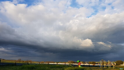 Fototapeta na wymiar Stormy sky before the rain over the playground.