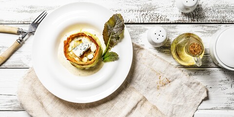 Food banner. Delicious vegetarian muffin with zucchini and blue cheese. Cheese sauce and mustard leaves. Tasty and healthy food. Restaurant serving and dish decoration. Food photography. Top view