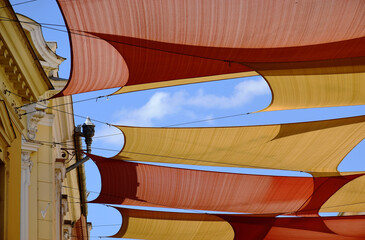 canvas patio awning. colorful tightly weaved sun shade sail. UV and sun protection fabric suspended...
