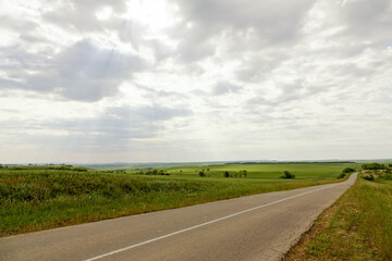 Rustic landscape abandoned farm with green grass in summer. old crumbling fence is a corral for cows and horses. concept is cattle breeding.