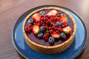 Fresh dietary dessert made of cow cream and frozen fruits and berries. Pie baked in oven. concept is vegetarian desserts.