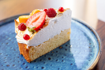 triangular piece of fresh diet dessert cake made of delicious cream and frozen fruits and berries. Raw food cake dessert. concept is vegetarian desserts.