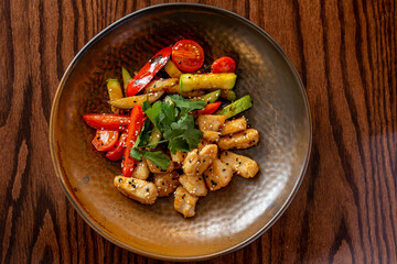 European Mediterranean salad of seasonal vegetables. Salad of tomatoes, cucumbers and fresh herbs with olive oil. Concept menu of summer cafe