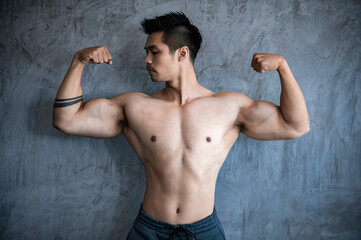 Obraz premium Portrait of asian man big muscle at the gym,Thailand people,Workout for good healthy,Body weight training,Fitness at the gym concept