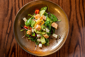 European Mediterranean salad of seasonal vegetables. Salad of tomatoes, cucumbers and fresh herbs with olive oil. Concept menu of summer cafe