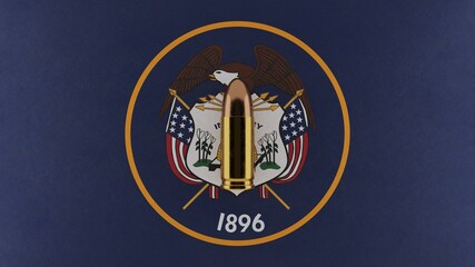 Top down view of a 9mm bullet in the center and on top of the US state flag of Utah