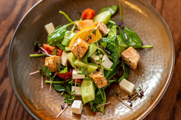 European Mediterranean salad of seasonal vegetables. Salad of tomatoes, cucumbers and fresh herbs with olive oil. Concept menu of summer cafe