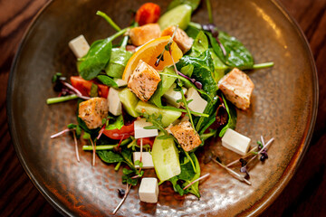 European Mediterranean salad of seasonal vegetables. Salad of tomatoes, cucumbers and fresh herbs with olive oil. Concept menu of summer cafe