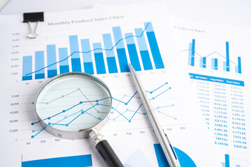 Magnifying glass on charts graphs paper. Financial development, Banking Account, Statistics,...