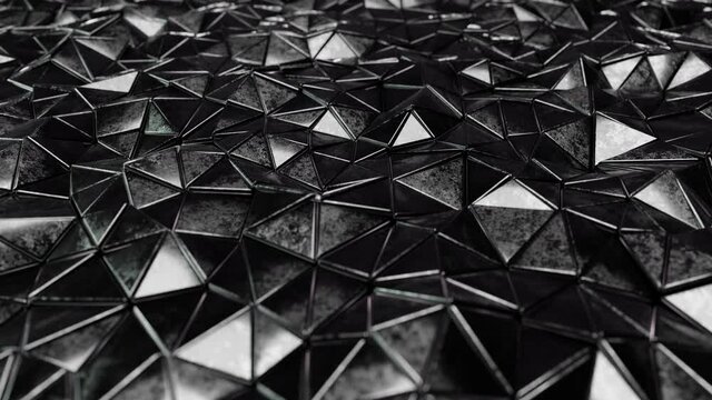 Realistic looping abstract 3D animation of the moving solid carbon black metallic triangles pattern rendered in UHD as motion background