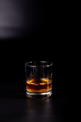 aperitif is an alcoholic cocktail made from various ingredients. Cocktail - one glass on a black background. concept is a holiday party.