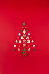 Christmas tree of cookies on the red background. Christmas holiday creative concept.