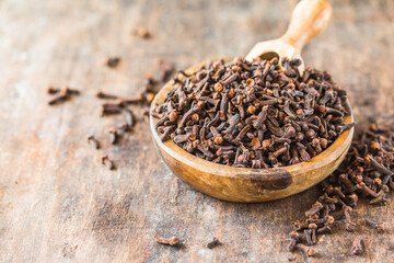 Dried clove seeds in a wooden bowl