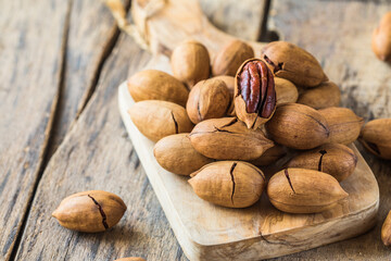 Cracked and opened pecan nuts and nuts in shell.