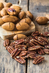 Cracked and opened pecan nuts and nuts in shell.