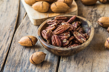 Cracked and opened pecan nuts and nuts in shell.