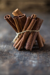 Ceylon cinnamon sticks on wooden background.