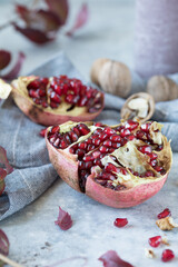 Several ripe pomegranate fruits and walnut. Pomegranate is rich in potassium, magnesium, calcium, iron, and manganese.