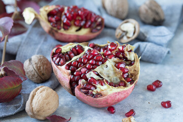Several ripe pomegranate fruits and walnut. Pomegranate is rich in potassium, magnesium, calcium, iron, and manganese.