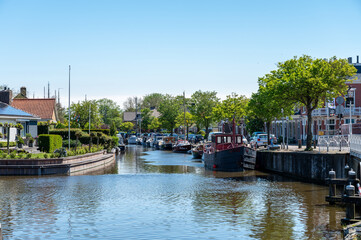 Naklejka premium Walking on old streets of Harlingen fisherman town on Wadden sea, Friesland, Netherlands