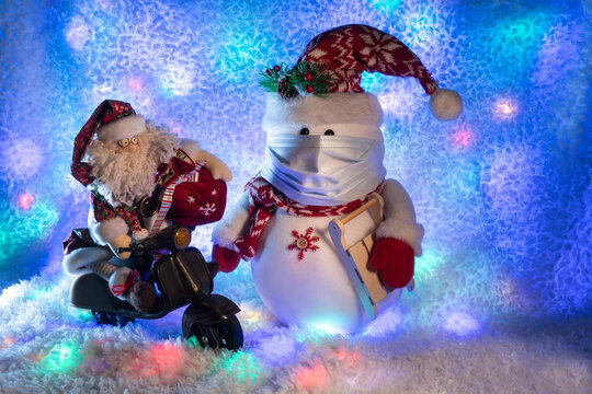 Rag Santa Claus on a toy motor scooter carrying a bag of gifts and snowman in mask