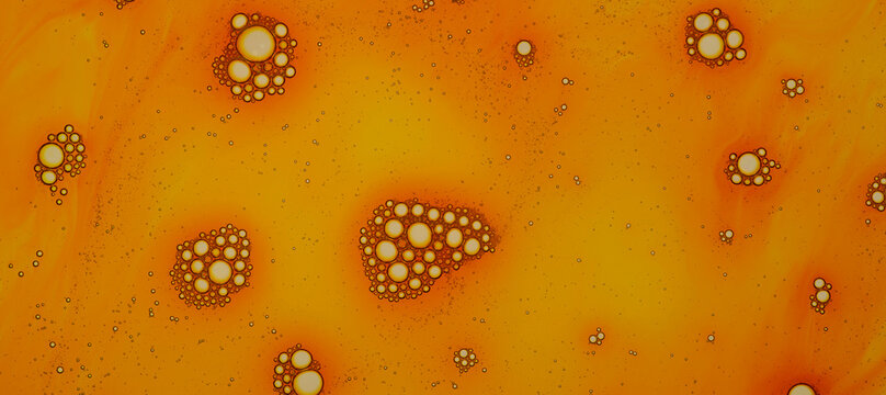 Orange bubbles banner, soap foam with orange liquid. Close up of texture. Flat lay top view