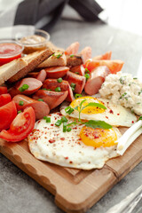 bruschetta with tomato, sausages and eggs
